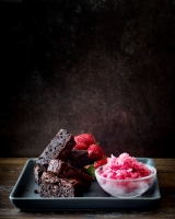 Sticky Chocolate Brownie with blood orange sorbet and strawberries
