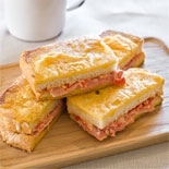 Smoked ham, semi-dried tomato & aioli toastie with parmesan